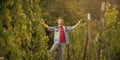 happy vineyard owner presenting his winery with grape harvest, happiness