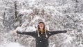 Happy vivacious woman celebrating the snow