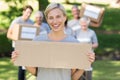 Happy volunteer blonde holding blank