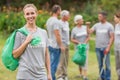 Happy volunteer collecting rubbish