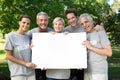 Happy volunteer family holding a blank