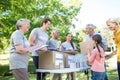 Happy volunteer family separating donations stuffs Royalty Free Stock Photo