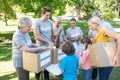 Happy volunteer family separating donations stuffs