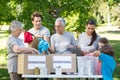 Happy volunteer family separating donations stuffs Royalty Free Stock Photo