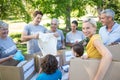 Happy volunteer family separating donations stuffs Royalty Free Stock Photo