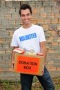 Happy volunteer with food donation box