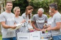 Happy volunteer looking at donation box Royalty Free Stock Photo