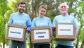 Happy volunteers holding donation cardboxes, humanitarian aid assistance project