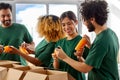 happy volunteers packing food in donation boxes Royalty Free Stock Photo