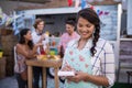 Happy waitress writing order in notepad