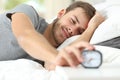 Happy wake up of a happy man stopping alarm clock Royalty Free Stock Photo