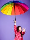 Happy walk under umbrella. Enjoy rain concept. Kid girl happy hold colorful rainbow umbrella. Rainy weather with proper Royalty Free Stock Photo