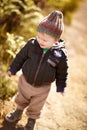 Happy, walking and child in nature on adventure, hiking and freedom on dirt path to explore. Countryside, childhood and
