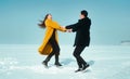 Happy walking couple. In love man and woman walking on the snowy ice. Winter vacation concept. Royalty Free Stock Photo