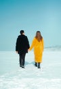 Happy walking couple. In love man and woman walking on the snowy ice. Winter vacation concept. Royalty Free Stock Photo