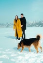 Happy walking couple. In love man and woman walking on the snowy ice. Winter vacation concept. Royalty Free Stock Photo