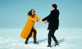 Happy walking couple. In love man and woman walking on the snowy ice. Winter vacation concept. Royalty Free Stock Photo