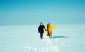 Happy walking couple. In love man and woman walking on the snowy ice. Winter vacation concept. Royalty Free Stock Photo