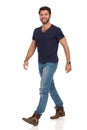 Happy Walking Man In Blue T-shirt, Jeans And Boots Royalty Free Stock Photo