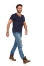 Happy Walking Man In Blue T-shirt, Jeans And Boots Looking At Camera Royalty Free Stock Photo