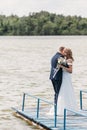 Happy wedding couple on bridge hugging Royalty Free Stock Photo