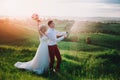 Happy wedding couple with buttle of champaine and splashes of champagne Royalty Free Stock Photo