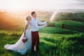 Happy wedding couple with buttle of champaine and splashes of champagne Royalty Free Stock Photo