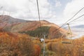 A happy wedding couple goes uphill on a mountain lift. Groom and bride. Royalty Free Stock Photo