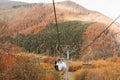 A happy wedding couple goes uphill on a mountain lift. Groom and bride. Royalty Free Stock Photo