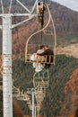 A happy wedding couple goes uphill on a mountain lift. Groom and bride. Royalty Free Stock Photo