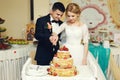 Happy wedding couple handsome groom and blonde bride carving del