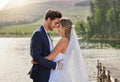 Happy wedding couple, hug and love by lake for romantic honeymoon getaway in nature. Man and woman hugging touching Royalty Free Stock Photo