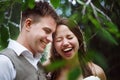 Happy wedding couple laughing in the park Royalty Free Stock Photo