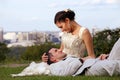 Happy wedding couple lying down on the grass Royalty Free Stock Photo