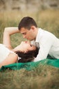 Happy wedding couple lying on green grass at the summer time Royalty Free Stock Photo