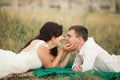 Happy wedding couple lying on green grass at the summer time Royalty Free Stock Photo