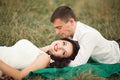 Happy wedding couple lying on green grass at the summer time Royalty Free Stock Photo