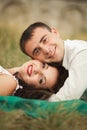 Happy wedding couple lying on green grass at the summer time Royalty Free Stock Photo