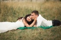 Happy wedding couple lying on green grass at the summer time Royalty Free Stock Photo