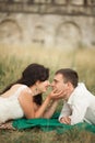 Happy wedding couple lying on green grass at the summer time Royalty Free Stock Photo