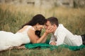 Happy wedding couple lying on green grass at the summer time Royalty Free Stock Photo