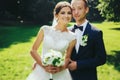 Happy wedding couple poses in the garden