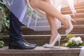 Happy wedding couple on stairs outdoors