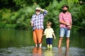 Happy weekend concept. Fly fishing. Grandfather, father and grandson fishing together. Men day. Grandpa and grandson are Royalty Free Stock Photo