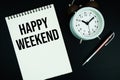 Happy Weekend text written on notepad with pen and alarm clock Royalty Free Stock Photo