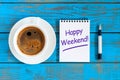 Happy weekend wishes with morning coffee cup at blue wooden rustic background, flat lay