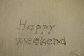 Happy weekend written on a tropical white sand beach Royalty Free Stock Photo