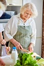 Happy weekends at home. Mature woman preparing food for family at kitchen