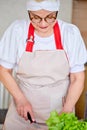 Happy weekends at home. Senior woman preparing food for family at kitchen