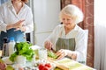 Happy weekends at home. Senior woman preparing food for family at kitchen